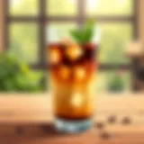 Refreshing Cold Coffee A refreshing glass of cold coffee with ice cubes and a sprig of mint.